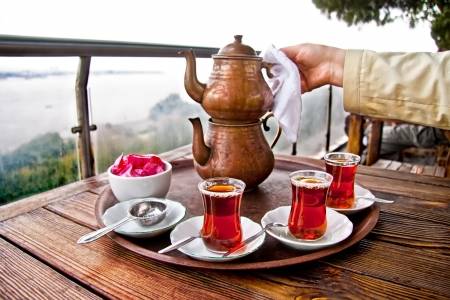 21847644-drinking-traditional-turkish-tea-with-turkish-tea-cup-and-copper-tea-pot.jpg